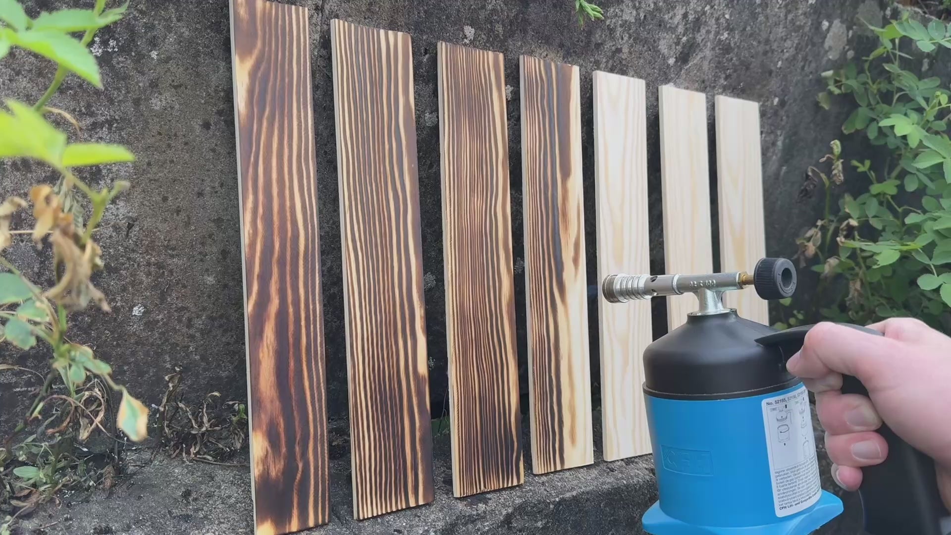 Load video: Burning wood panels, highlighting the natural pattern of the grain of the wood